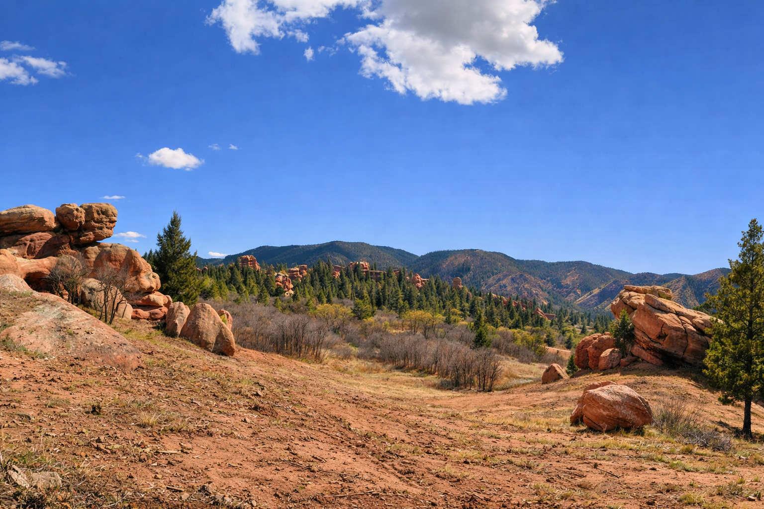 Spring Canyon landscape in Larkspur, Colorado with red rock formations, pine trees, and foothills